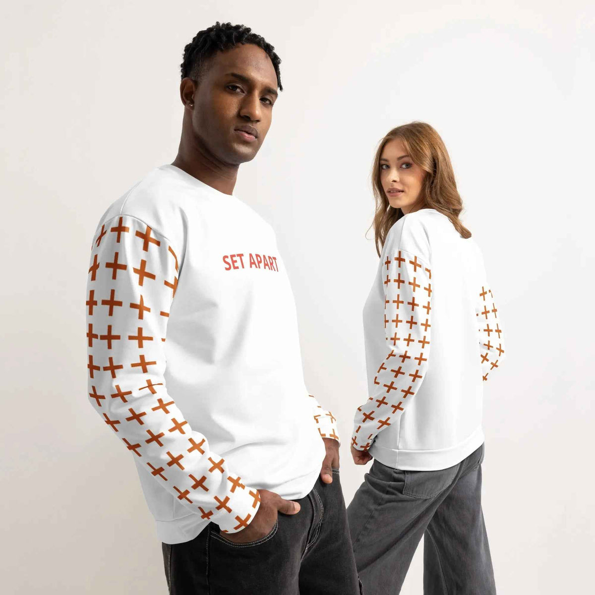 Two models wearing the white Ascension crewneck with SET APART lettering and cross-patterned sleeves